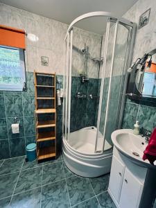 a bathroom with a shower and a tub and a sink at Zielony Dom in Węglówka +30 photos