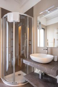 a bathroom with a large sink and a shower at Maison Cecile in Verbania