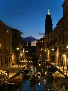 a group of boats in a canal at night at Ca' Matir in Venice
