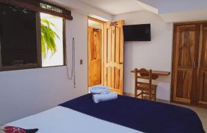 Postel nebo postele na pokoji v ubytování Famy Hostal Nardo's