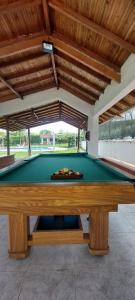 a pool table in a patio with awning at Hotel Chalet La Sofia by Majuva in Armenia