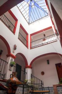 a building with a ceiling with a glass roof at Apartamentos Turisticos Casa Cantillo in Carmona