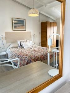 a bedroom with a bed and a mirror at Loft Amarillo in Tandil