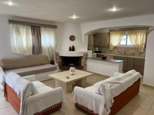 a living room with a couch and a table at Apartment in Salamina with Garden & Sea view in Selínia