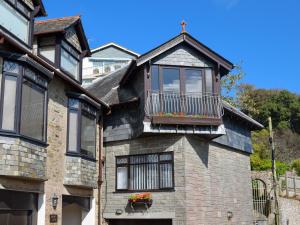 a house with a balcony on top of it at Wigwam in Salcombe