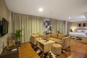 a living room with a couch and a table at Days Hotel & Suites by Wyndham Jakarta Airport in Tangerang