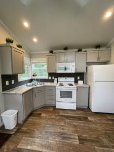 a kitchen with white cabinets and a white refrigerator at Charming New 1-BA/1-BR Home on an 60 Acre Property (Sleeps Up To 4) in Sardis