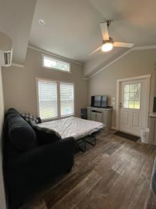 a living room with a couch and a table at Charming New 1-BA/1-BR Home on an 60 Acre Property (Sleeps Up To 4) in Sardis