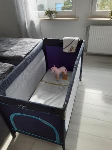 a bed with a toy pig sitting on the bed at Baumann's apartment - ruhige Lage in Grifte