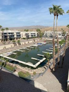 a rendering of a marina with palm trees and boats at Private Oasis Condo with River views across from Laughlin in Bullhead City