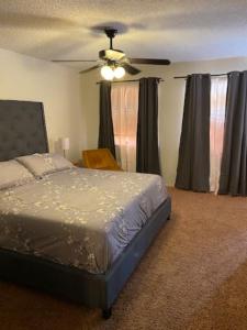 a bedroom with a bed and a ceiling fan at Private Oasis Condo with River views across from Laughlin in Bullhead City