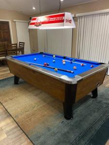 a pool table sitting in a living room with at Private Oasis Condo with River views across from Laughlin in Bullhead City