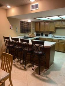 a kitchen with a large island with bar stools at Private Oasis Condo with River views across from Laughlin in Bullhead City