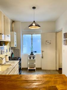 a kitchen with a large window and a stove at Mendoza R km 0 in Mendoza