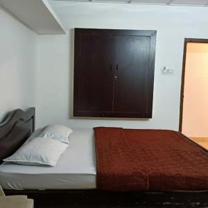 um quarto com uma cama e uma janela grande em RC HOMESTAY em Kodaikanal