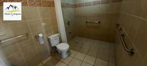 a bathroom with a toilet and a shower stall at Hotel Monte Campana Heredia in Birrí