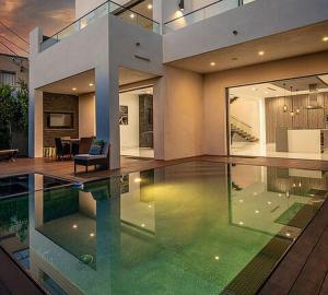 a large house with a swimming pool in front of it at Villa Huston in Los Angeles