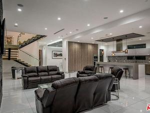 a large living room with leather furniture and a bar at Villa Huston in Los Angeles