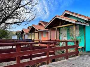 a house with a wooden fence in front of it at Pousada do Zezé in Bueno Brandão