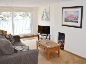 a living room with a couch and a coffee table at Nelson Steps 3 in Kingswear