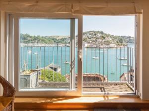 a room with a window with a view of a harbor at Nelson Steps 3 in Kingswear