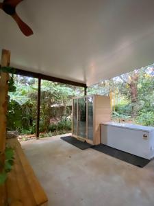 a glass house in the middle of a yard at Ananda Eco House - Eco Rainforest Retreat in Montville