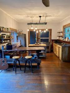 a large kitchen with a large wooden table and stool at Ananda Eco House - Eco Rainforest Retreat in Montville