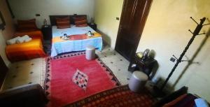 an overhead view of a bedroom with two beds and a red rug at Riad Atlas Panorama in Imlil