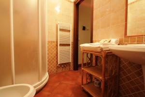 a bathroom with a shower and a sink and a toilet at B&B San Francesco in Siena