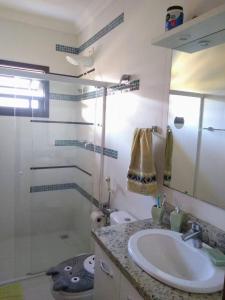 a bathroom with a sink and a shower at Recanto Primavera in Blumenau