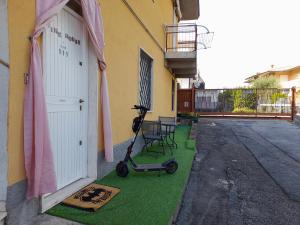 a scooter is parked next to a building at BIKE HOUSE 4 "beach" in Seriate