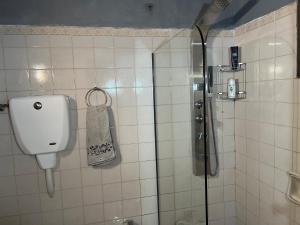 a bathroom with a shower with a soap dispenser at Dimensión Desconocida in Piriápolis +21 photos