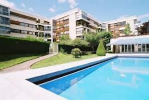 una gran piscina frente a un edificio en Chez MO, en Le Chesnay