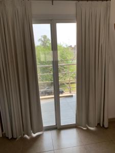 a room with a large window with curtains at Fénix 4 in Colón