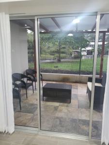 a screened in porch with a bench and a table at Casa en puntaleona Condomio Bambu in Quebrada Ganado