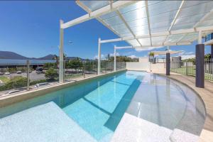 a swimming pool in a building with a roof at Seascape in Cairns