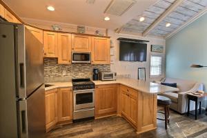a kitchen with wooden cabinets and stainless steel appliances at 35 SEA SEITZ condo in Hatteras