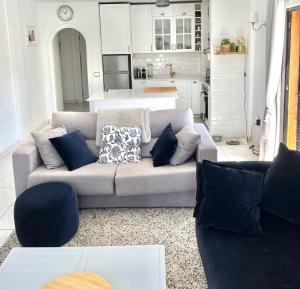 a living room with a couch and a kitchen at Sea View Penthouse with Large Terrace in Los Cristianos