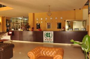 a lobby with a leather couch in a store at Churchill Addis Ababa Hotel in Addis Ababa