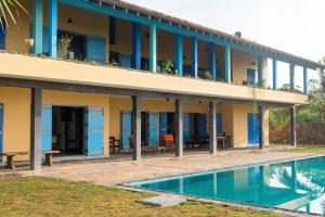 a building with a pool in front of it at Villa Atulya at Ocean's edge in Mirissa