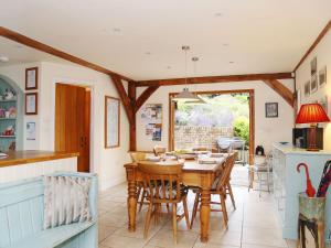 a kitchen and dining room with a table and chairs at The Hayloft in Chislet