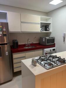 a kitchen with a stove and a counter top at Melhor localização Leblon, apartamento reformado in Rio de Janeiro