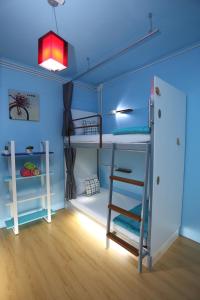 a room with two bunk beds with a ladder at iDeal Beds Hostel Ao Nang Beach in Ao Nang Beach