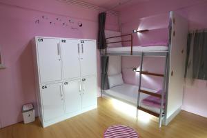 a pink room with a bunk bed and a ladder at iDeal Beds Hostel Ao Nang Beach in Ao Nang Beach