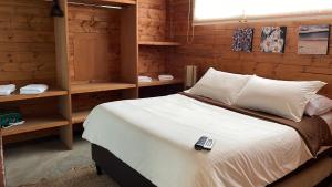 a bedroom with a bed with a remote control on it at Portal de Iza in Iza