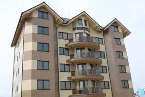 a tall building with balconies on it at Hotel Kotva in Bratislava