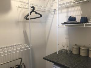 a kitchen with white walls and a glass shelf at Lakeview Terrace Accommodation in Cromwell
