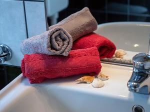 ein Stapel Handtücher auf einem Waschbecken in der Unterkunft Apartments Suzy - 80m from the sea in Supetarska Draga