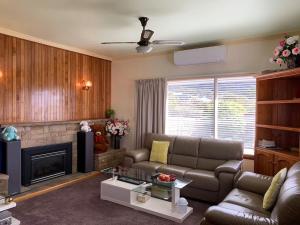 a living room with a couch and a fireplace at Rose Homey Home in Glenorchy