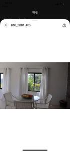 a dining room with a table and a window at Ogumka 2 , self catering , Santa Maria , Mahe , Seychelles in Anse Royale